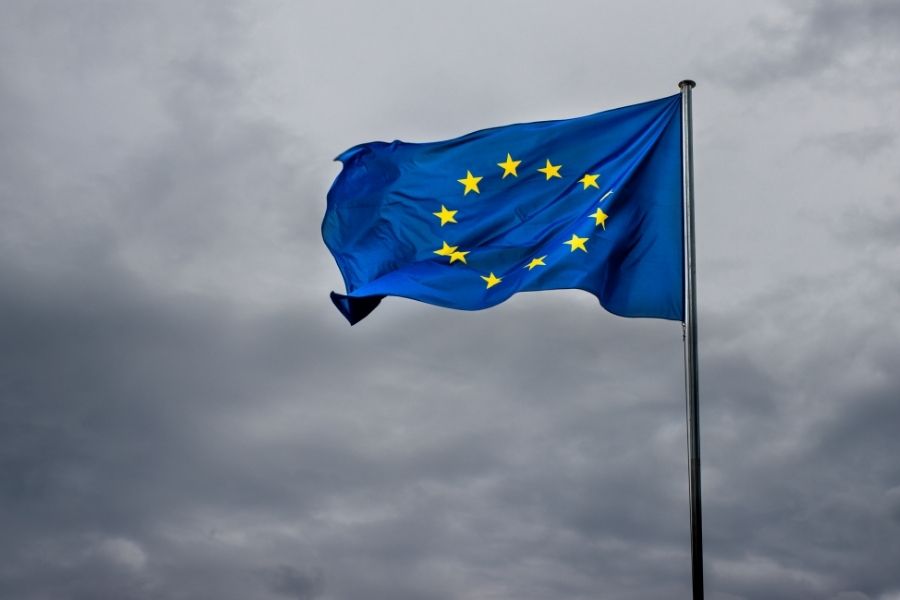 European Union flag waving in the wind, symbolizing political shifts in Europe and their global impact.
