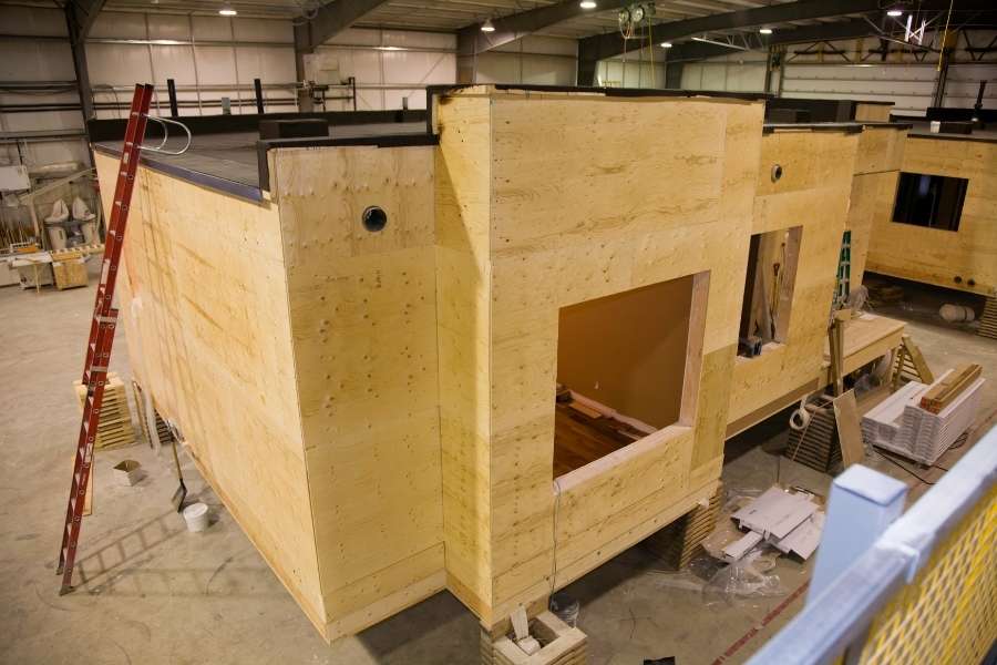 Prefabricated building modules under construction in industrial facility showcasing modular construction manufacturing process