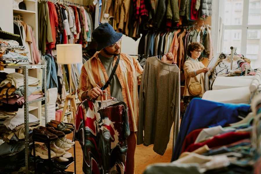 An inviting vintage clothing boutique showcasing various items, encouraging sustainable shopping habits.