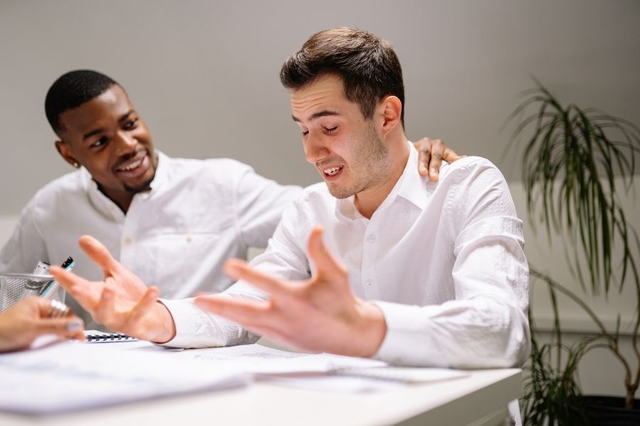 Two professionals discussing AI ethics during a meeting.