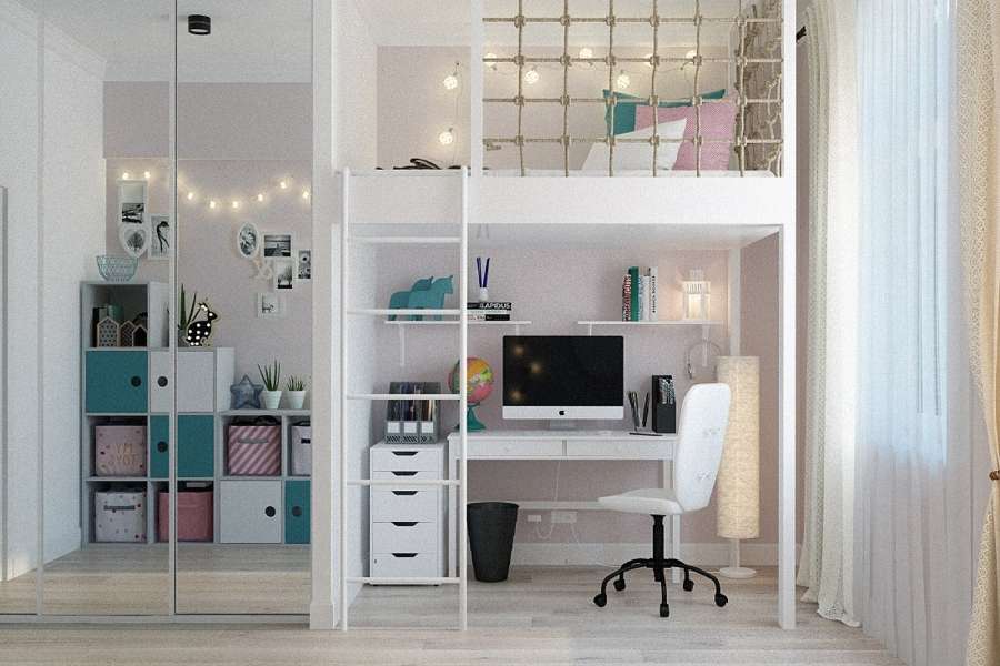 A compact, stylish home office set up underneath a loft bed with a white desk, computer, and rolling chair.